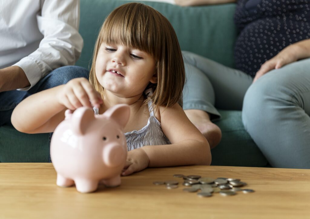 Family saving money in piggy bank